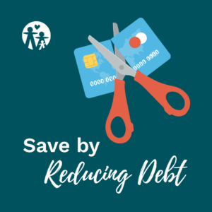 A credit card being cut in half by a pair of scissors.